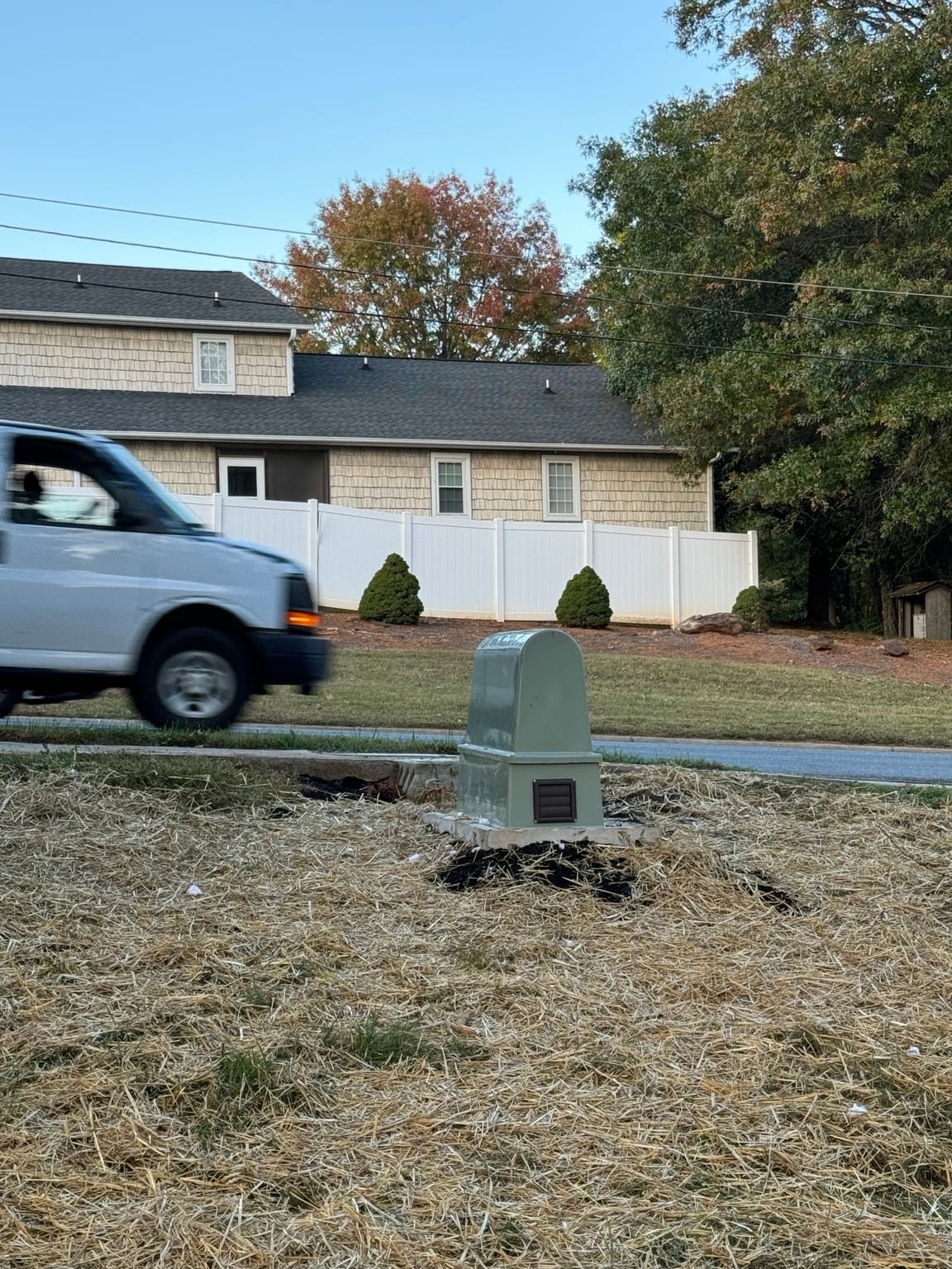 Backflow preventer installed inside a green protective enclosure on a concrete pad