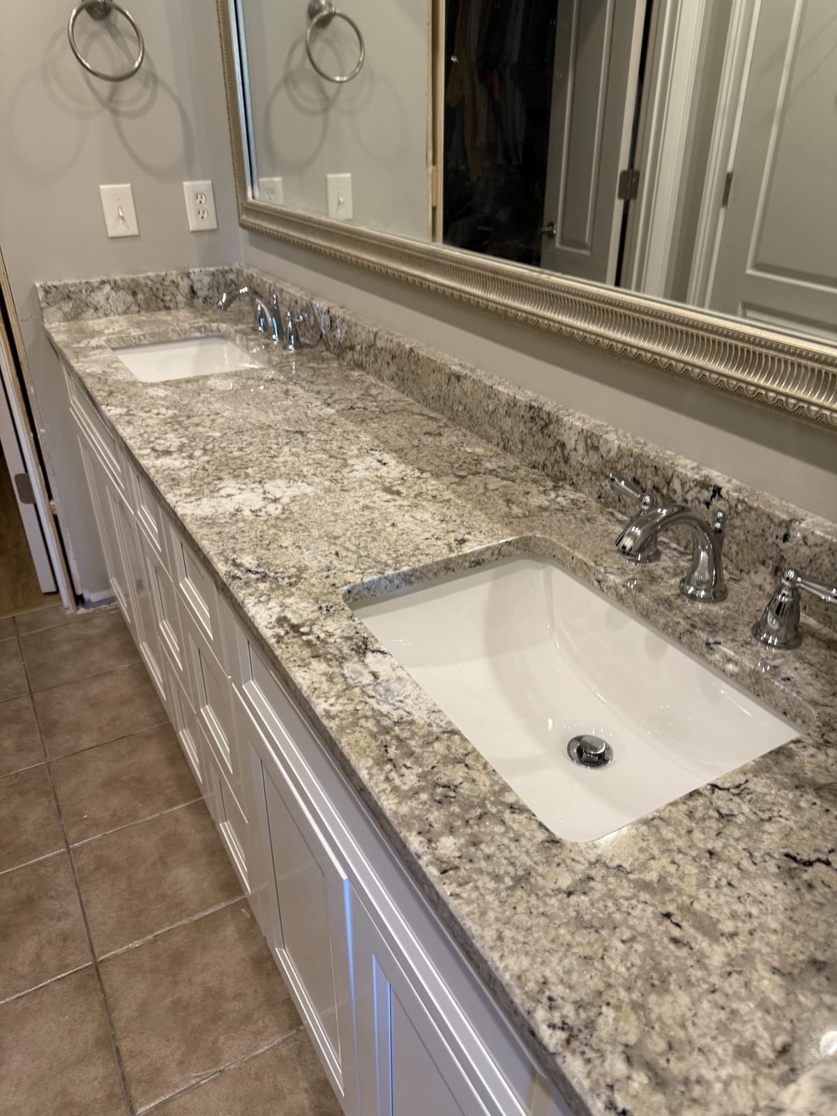 Double bathroom vanity with new faucets and undersink plumbing
