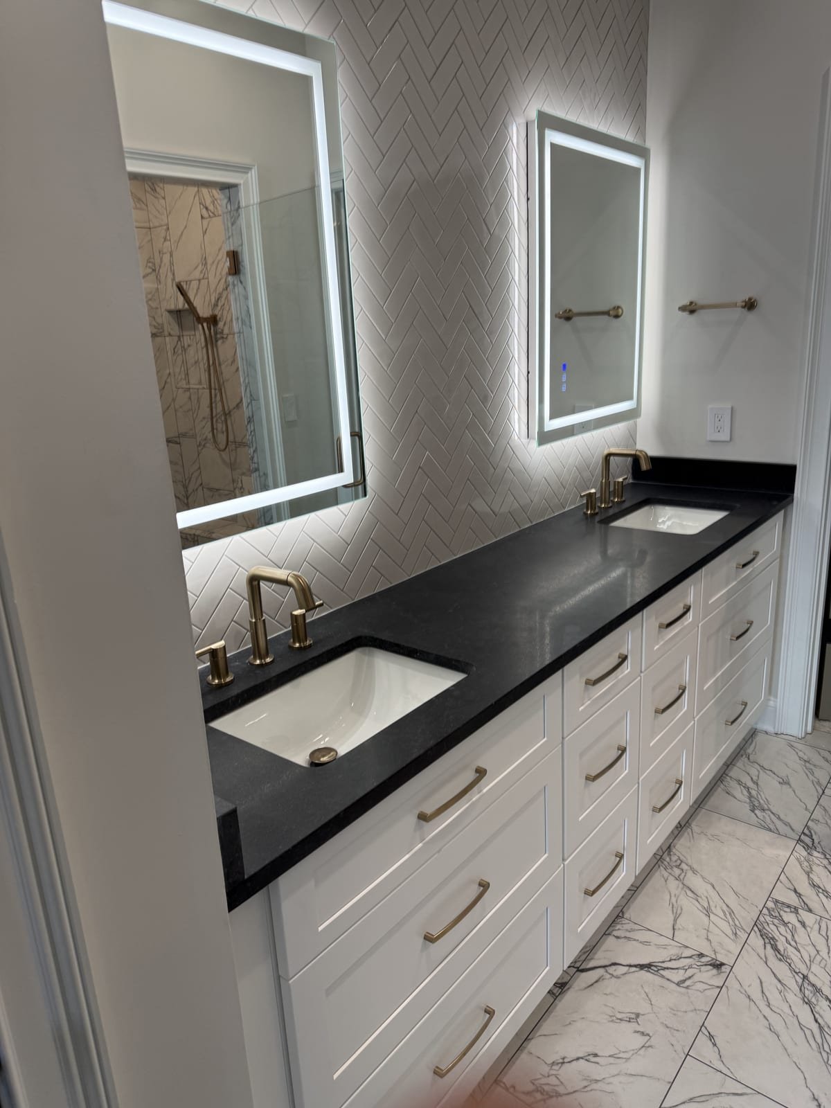 Upscale double vanity with designer faucets in a finished bathroom