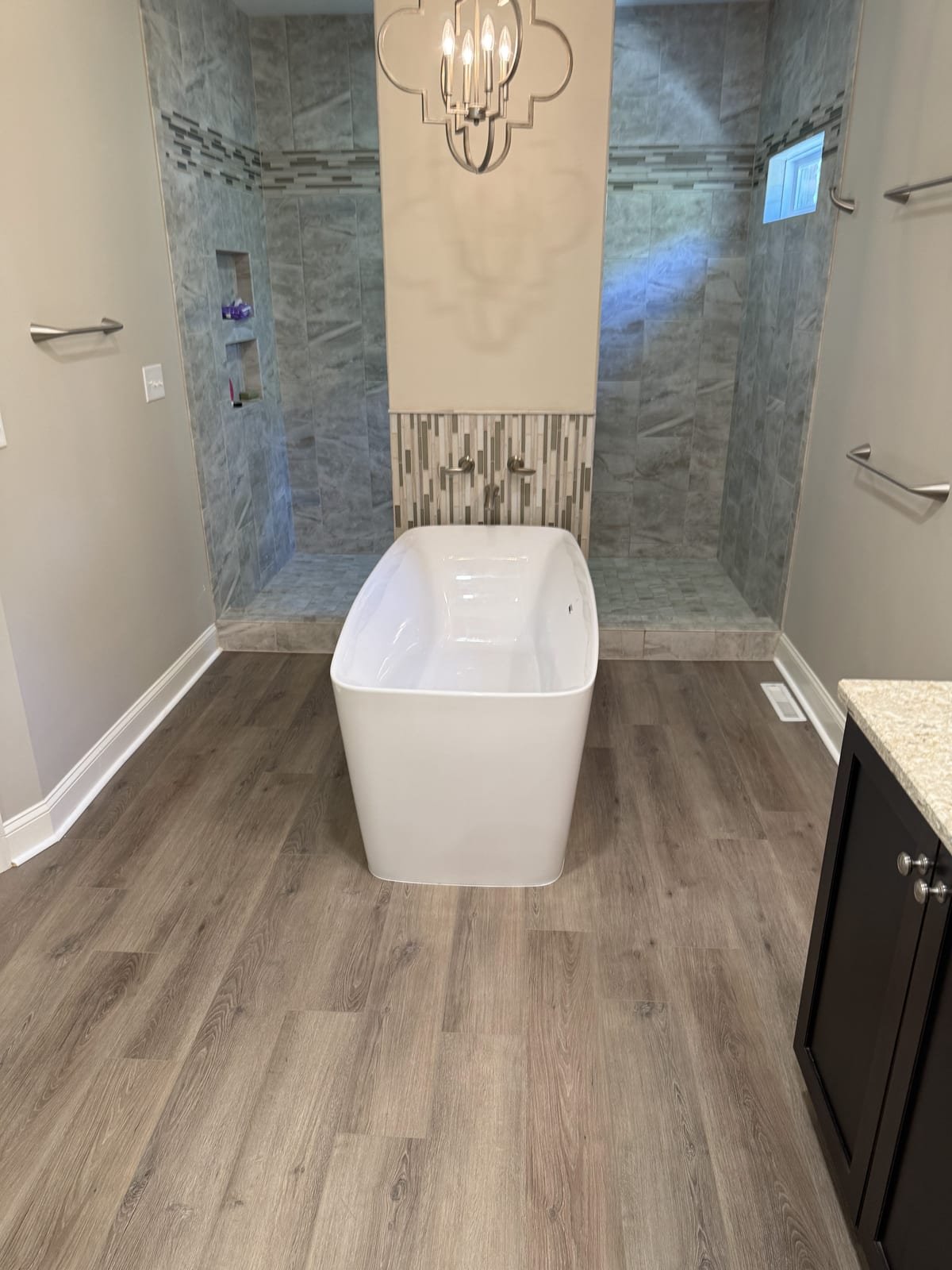 Freestanding soaking tub with floor-mounted tub filler