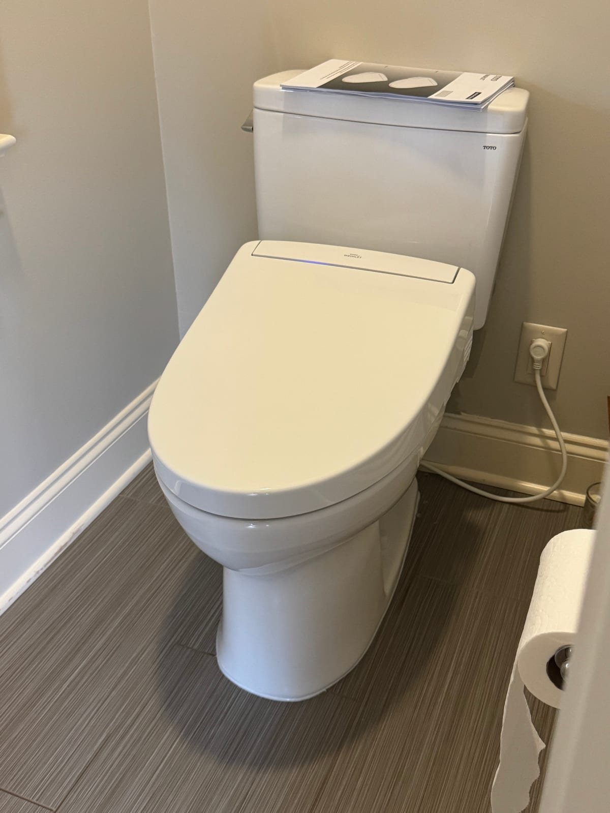 Toto toilet fitted with a bidet seat and its water supply connection