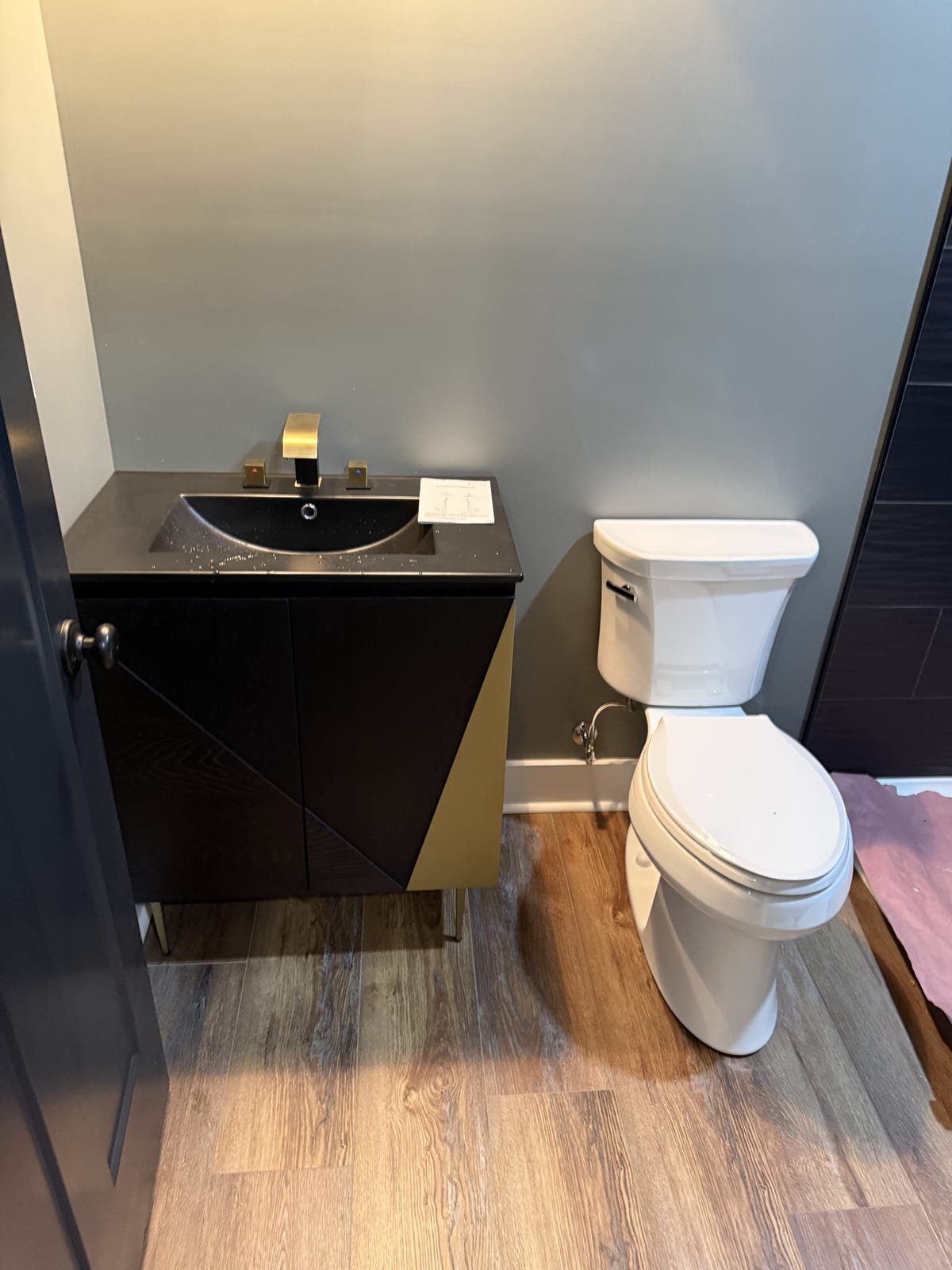 Newly finished bathroom with installed toilet, sink and shower fixtures