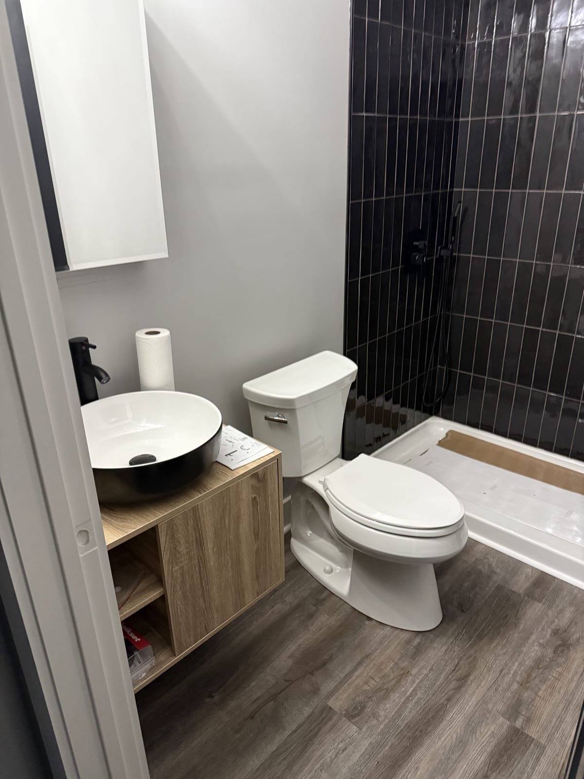 Remodeled bathroom with tiled shower and new vanity plumbing