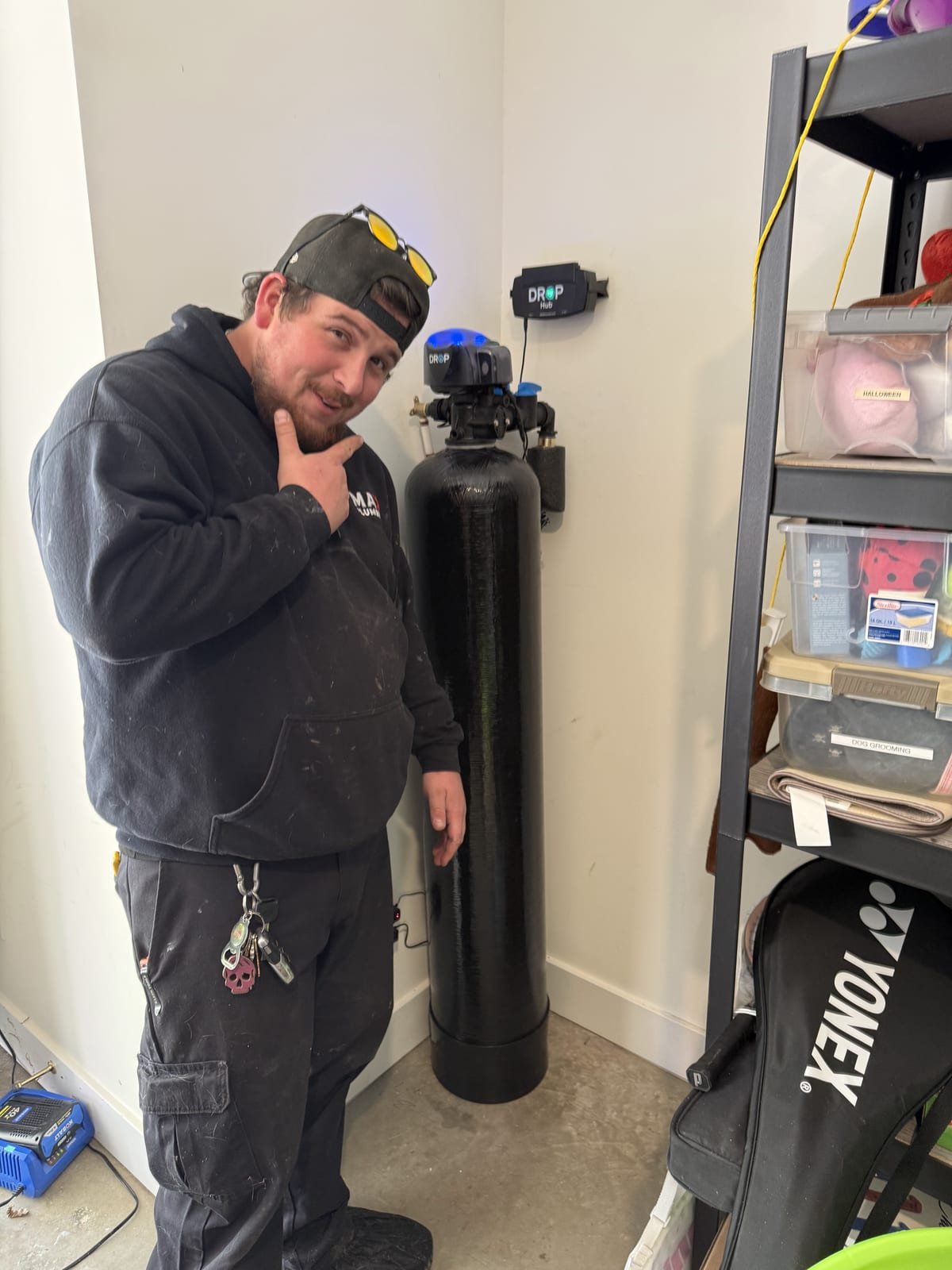 Technician installing a whole-home water filtration system