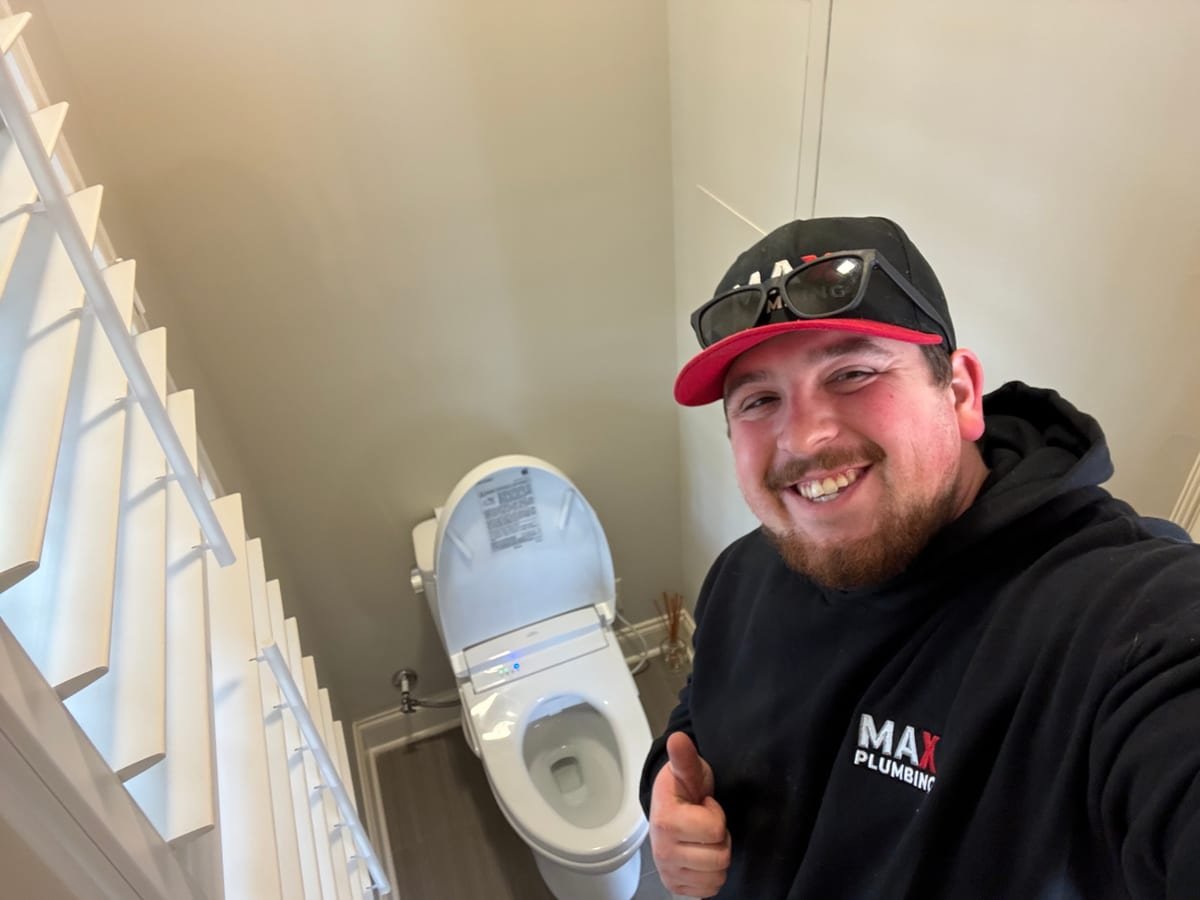 MAX Plumbing technician completing a toilet installation