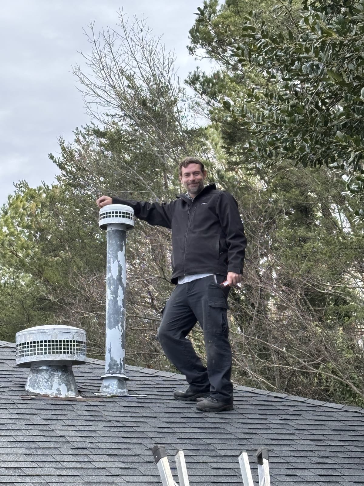 MAX Plumbing technician working on a roof vent