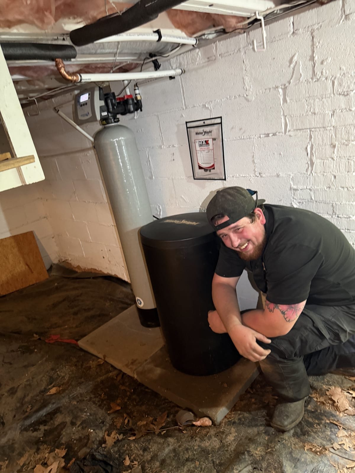 MAX Plumbing technician completing a water softener installation