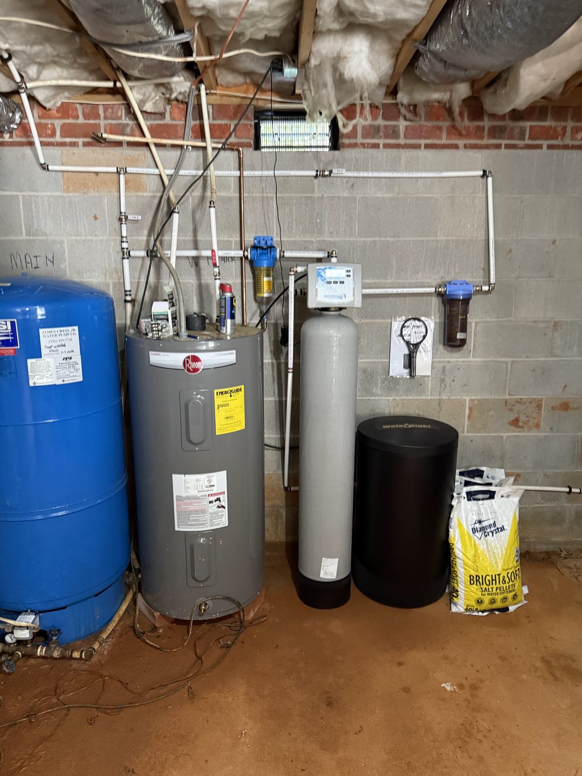Water softener installed on an incoming water line with a bypass loop