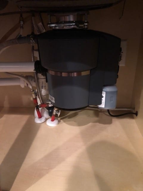 InSinkErator garbage disposal mounted under a kitchen sink