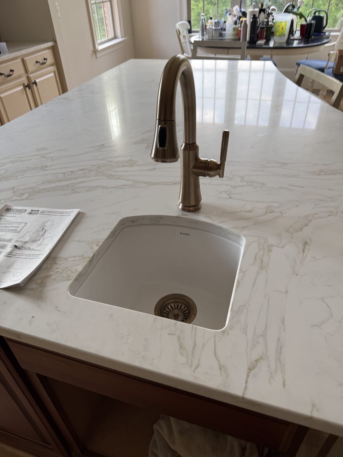 Kitchen island sink with drain and vent plumbing routed below