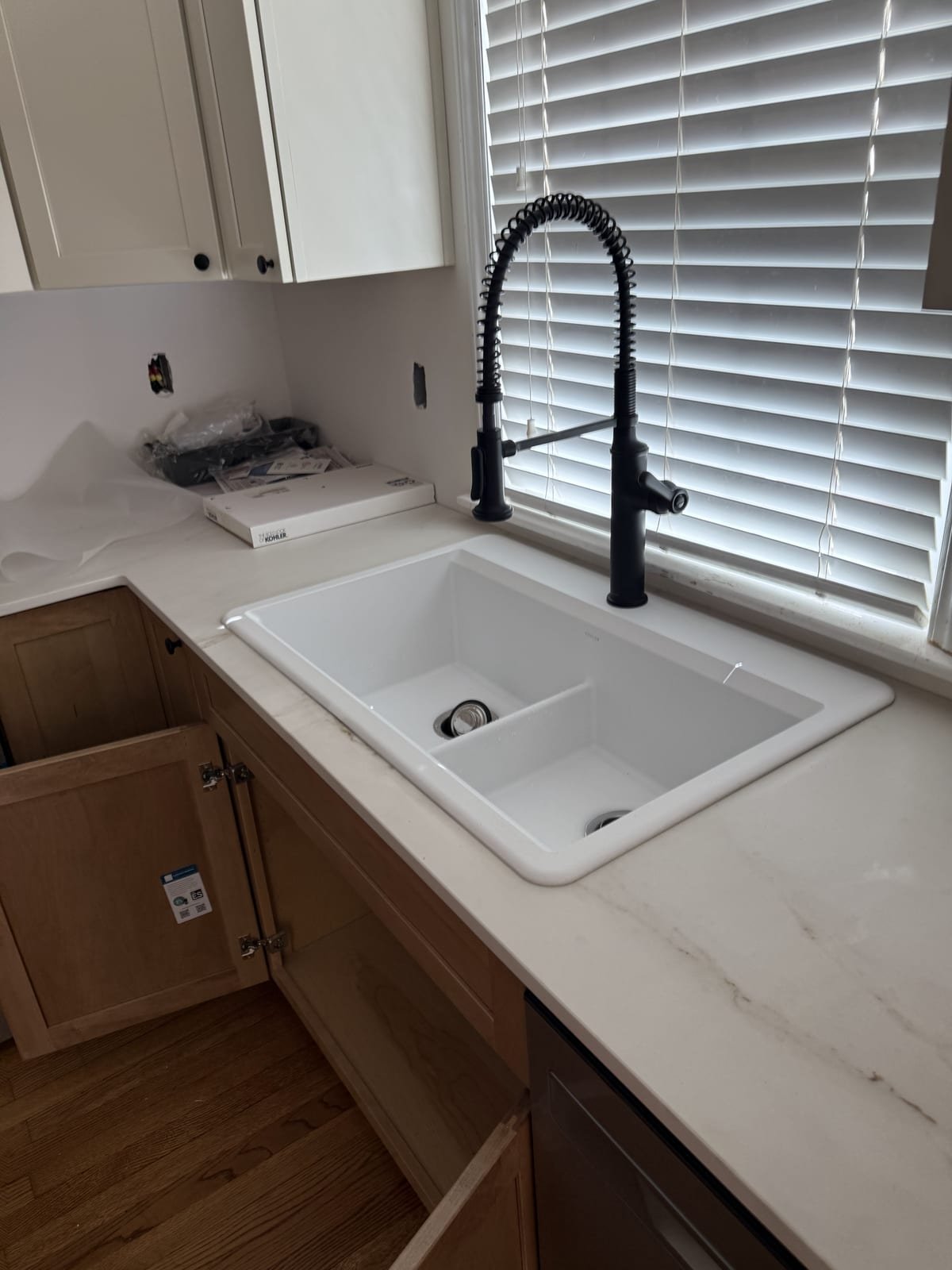 New kitchen sink with a matte black faucet installed