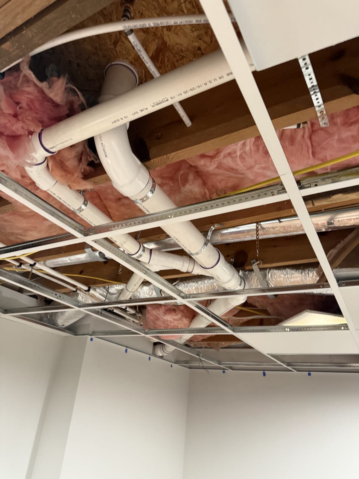 New bathroom drainage piping installed during construction