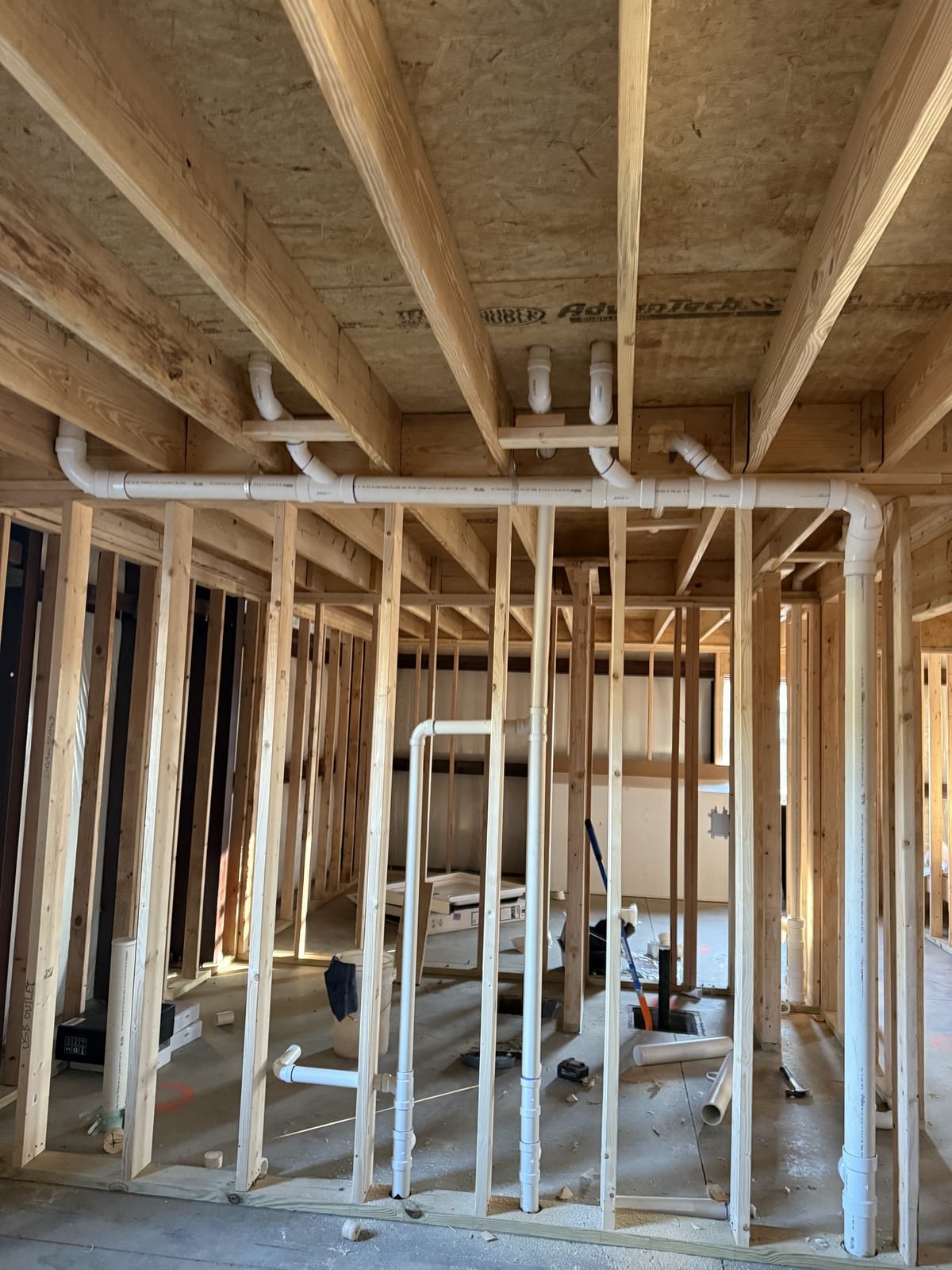 Rough plumbing installed in a new house before walls are closed in