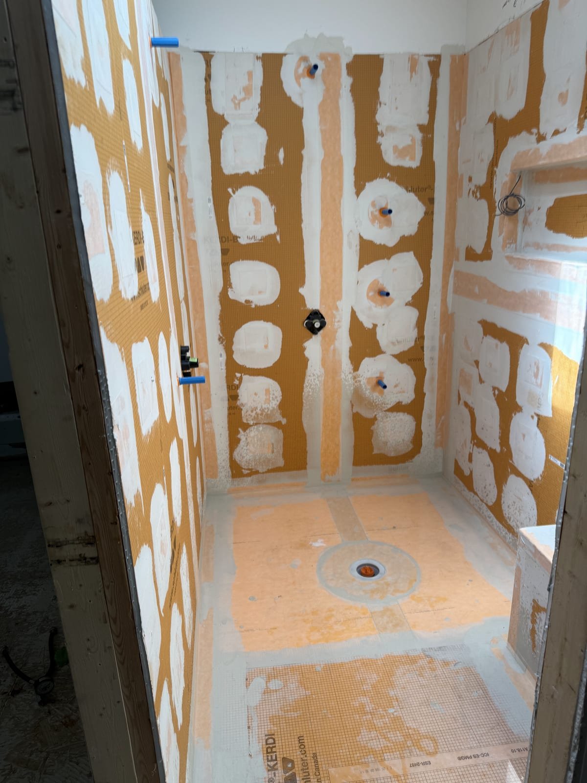 Large custom shower rough-in with multiple valve bodies installed