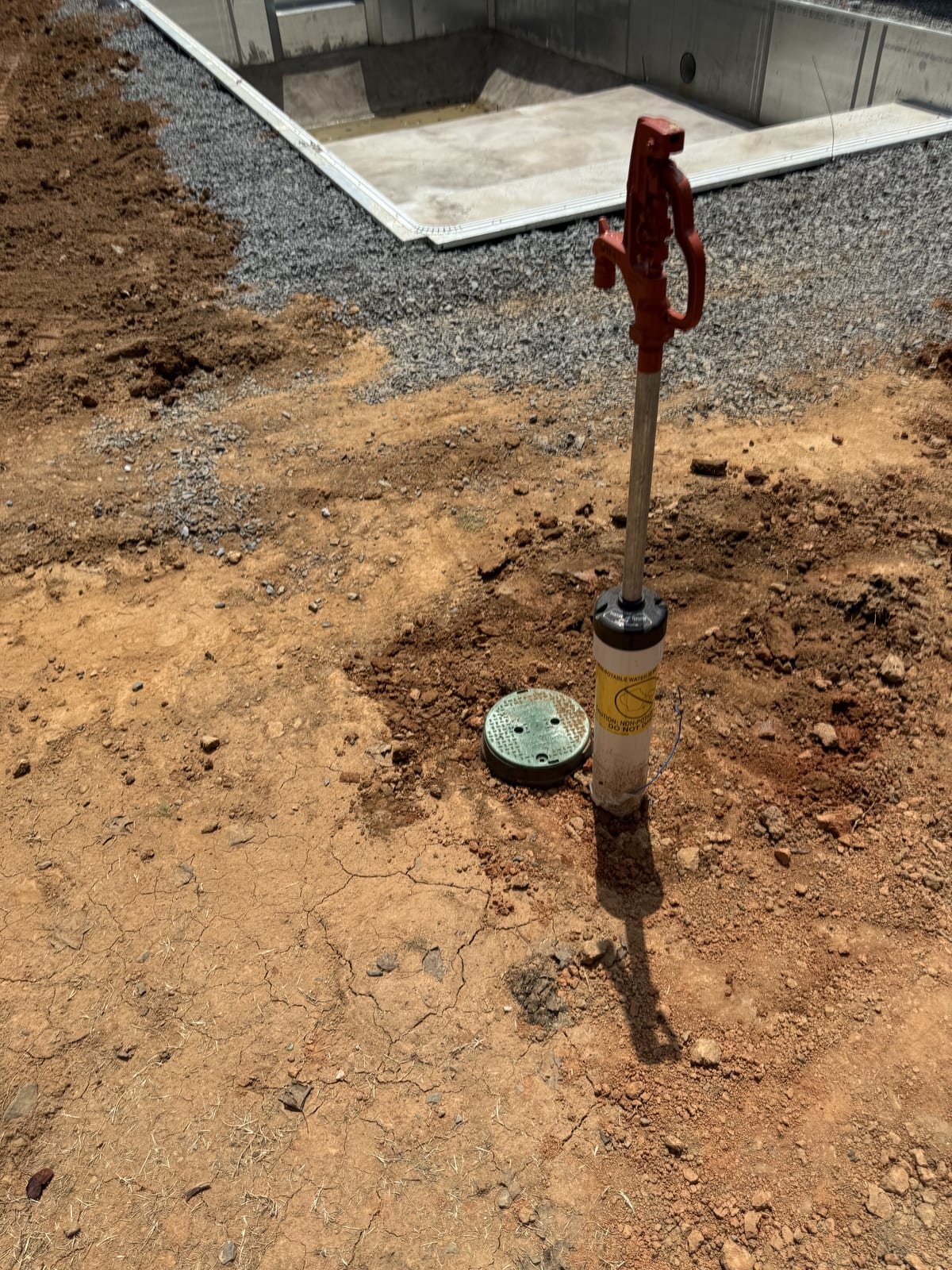 Yard hydrant being installed with a supply line trenched to it