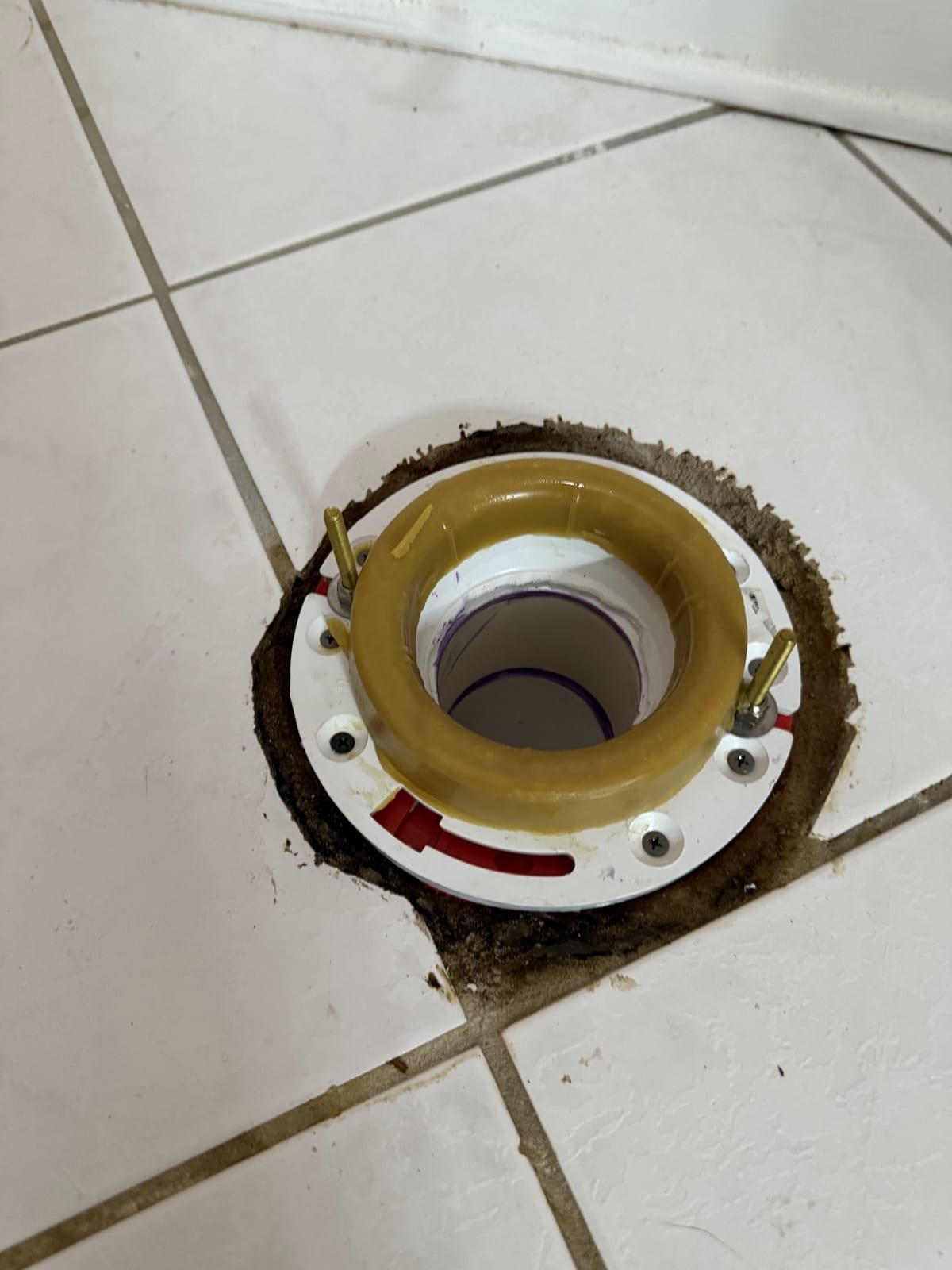 New toilet flange installed on a repaired drain connection