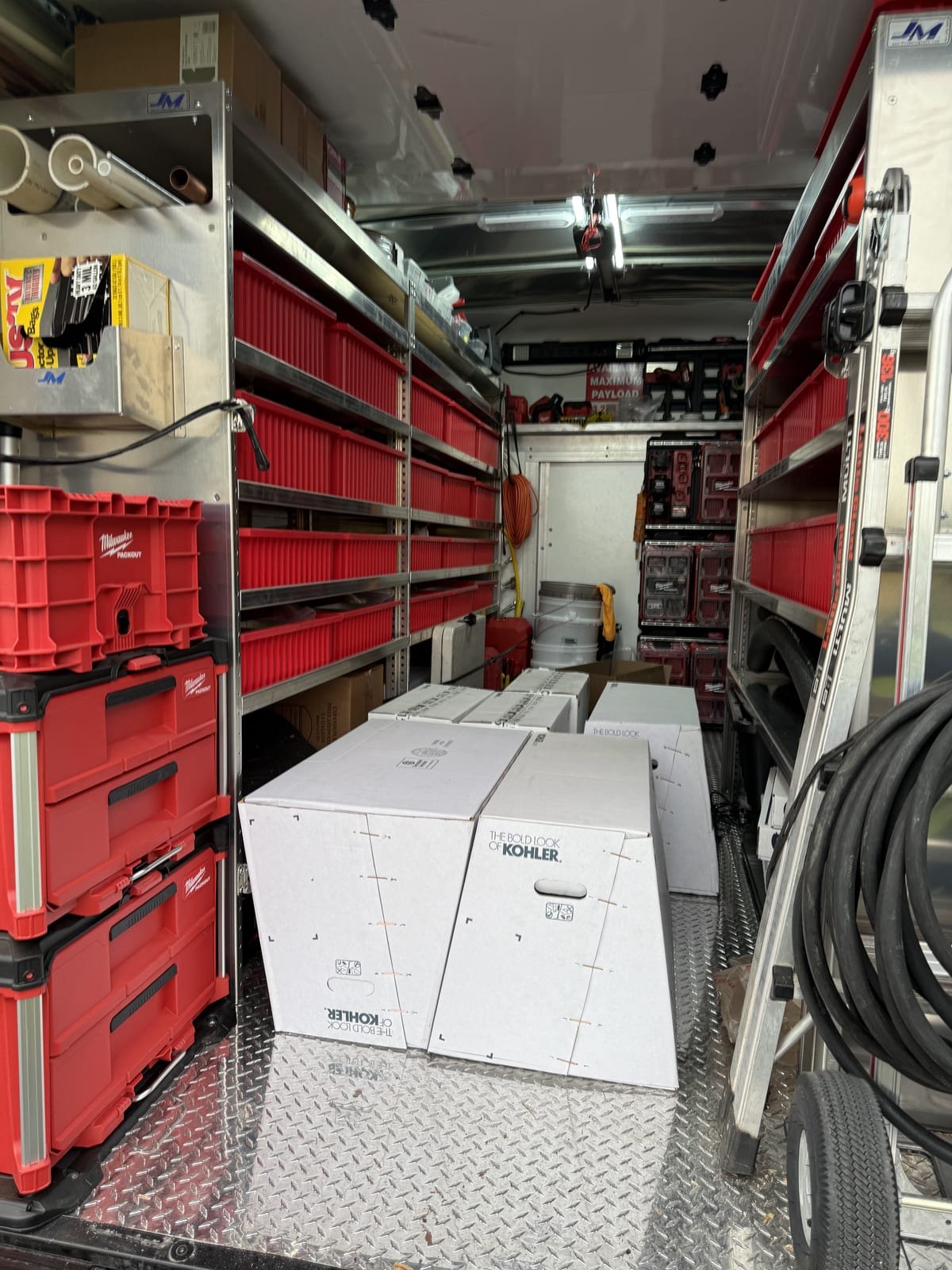 New toilets loaded and secured in an organized MAX Plumbing service van