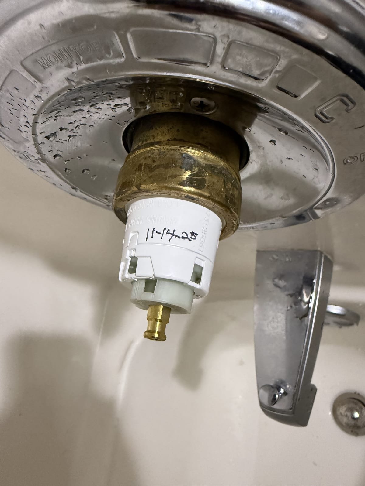 Worn shower valve cartridge removed during a repair