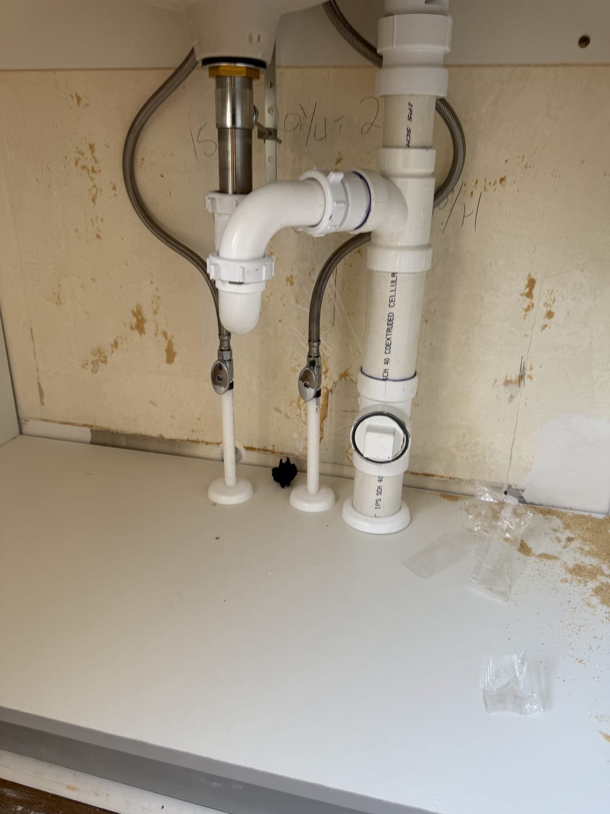 Rebuilt under-sink drain and supply plumbing
