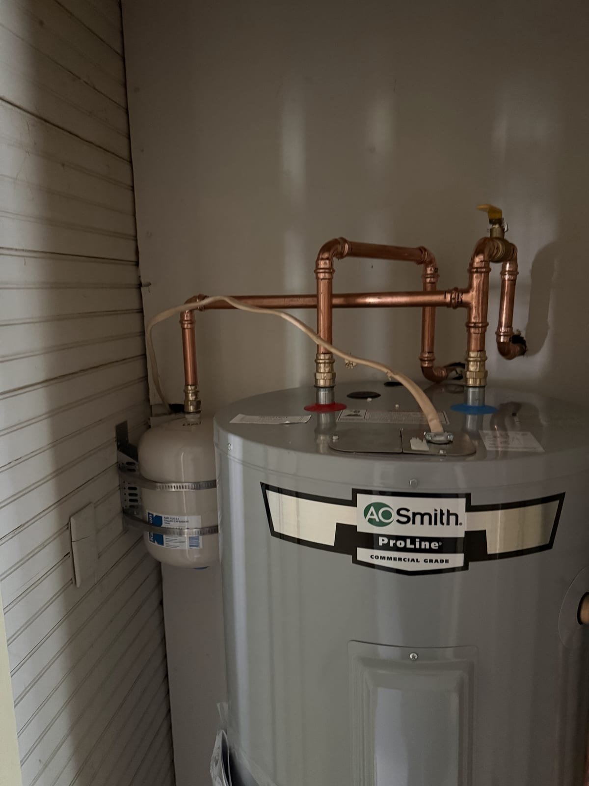 Replacement electric water heater piped and ready for service