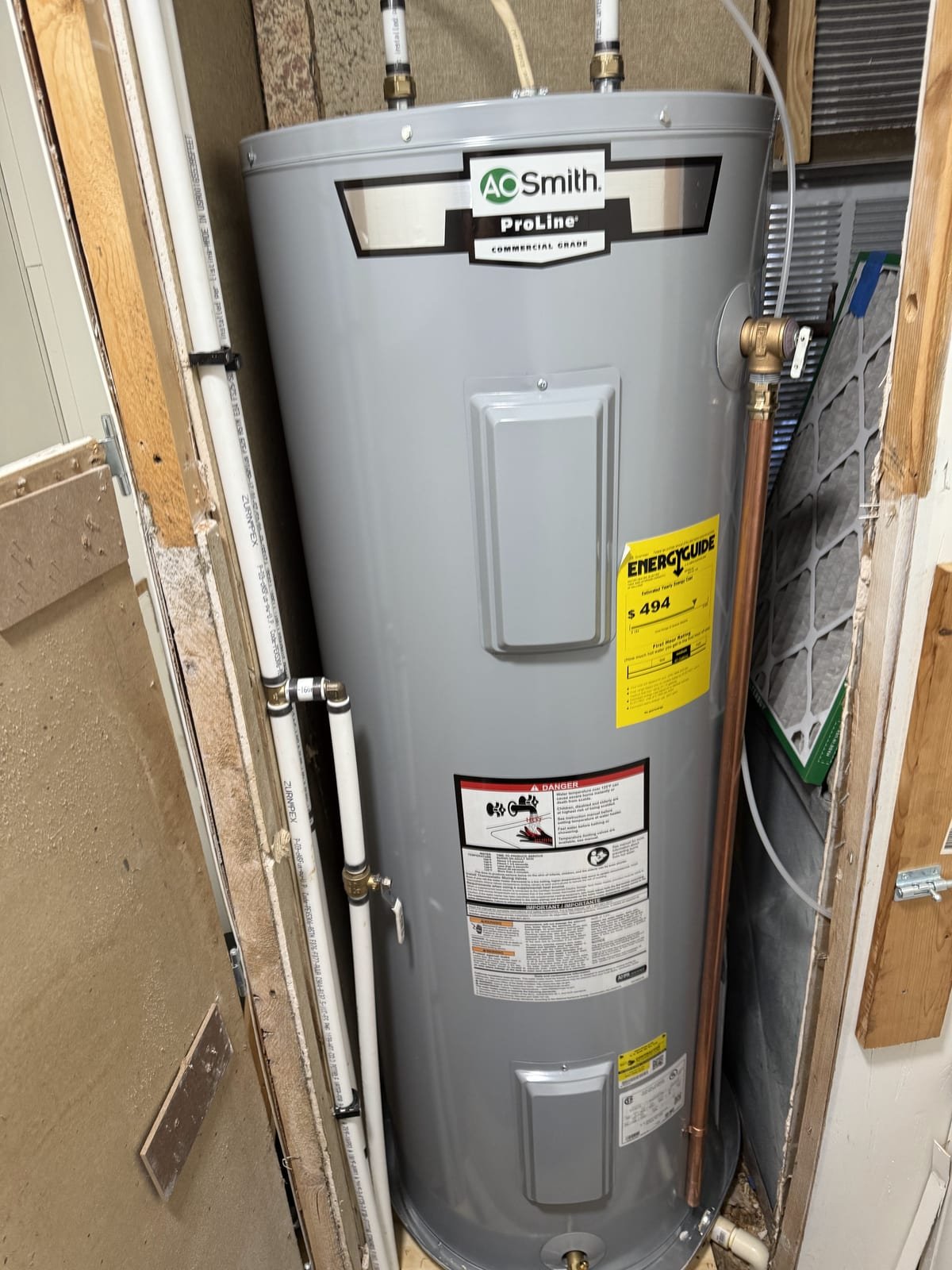 Newly installed electric water heater with insulated hot water line