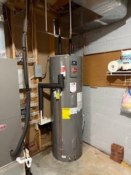 Rheem hybrid heat-pump water heater installed in a garage utility space