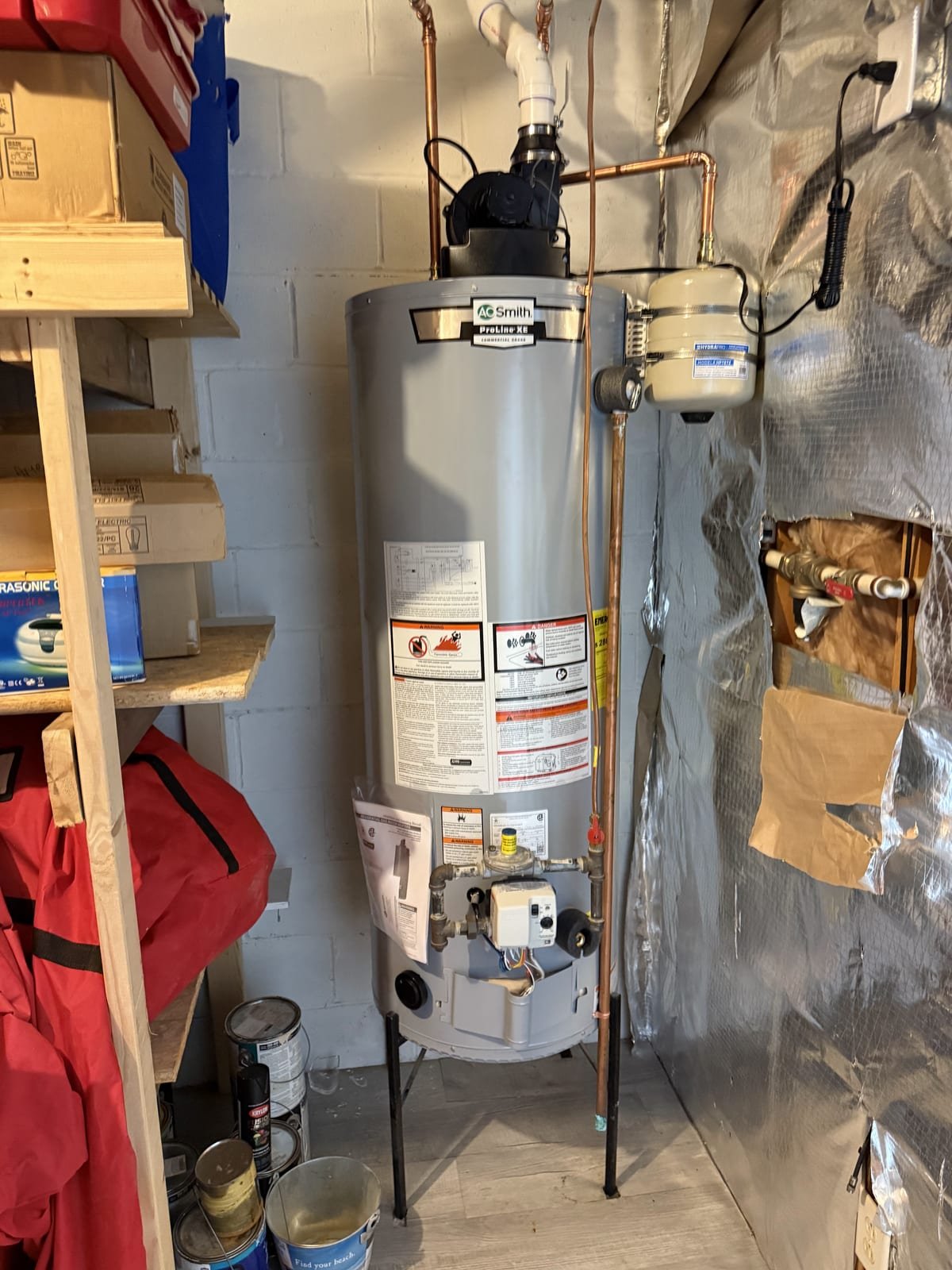 Power-vent gas water heater with vent piping and condensate handling
