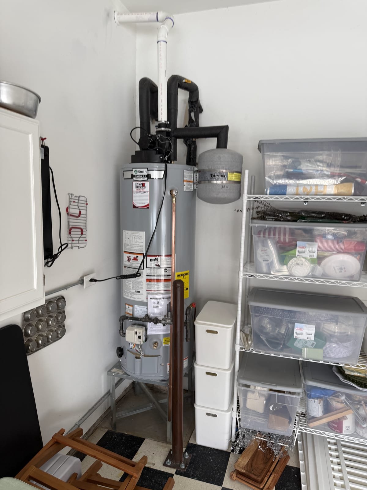Power-vent gas water heater installed with a blower and PVC vent run