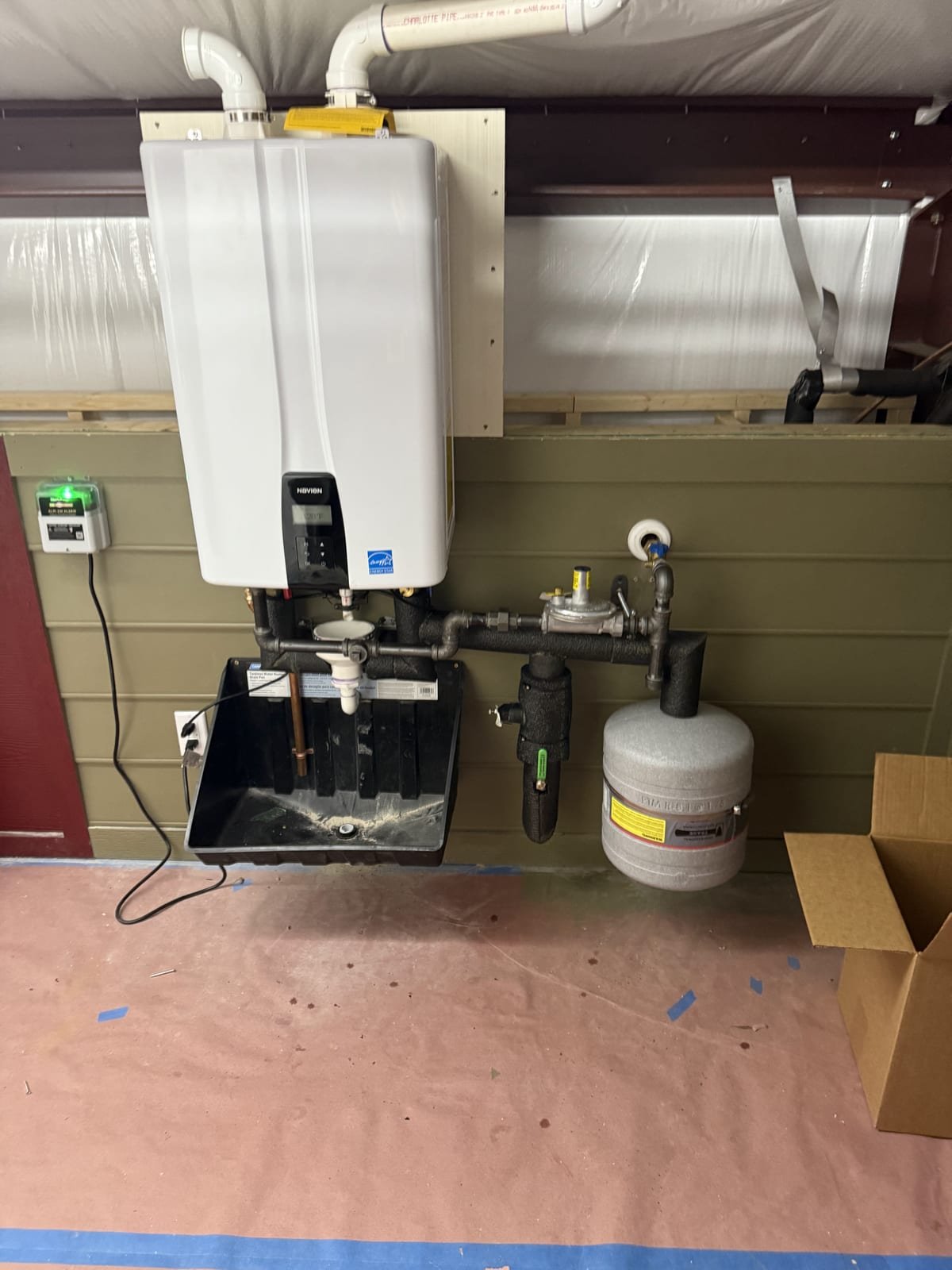 Navien tankless water heater installed with venting and supply connections
