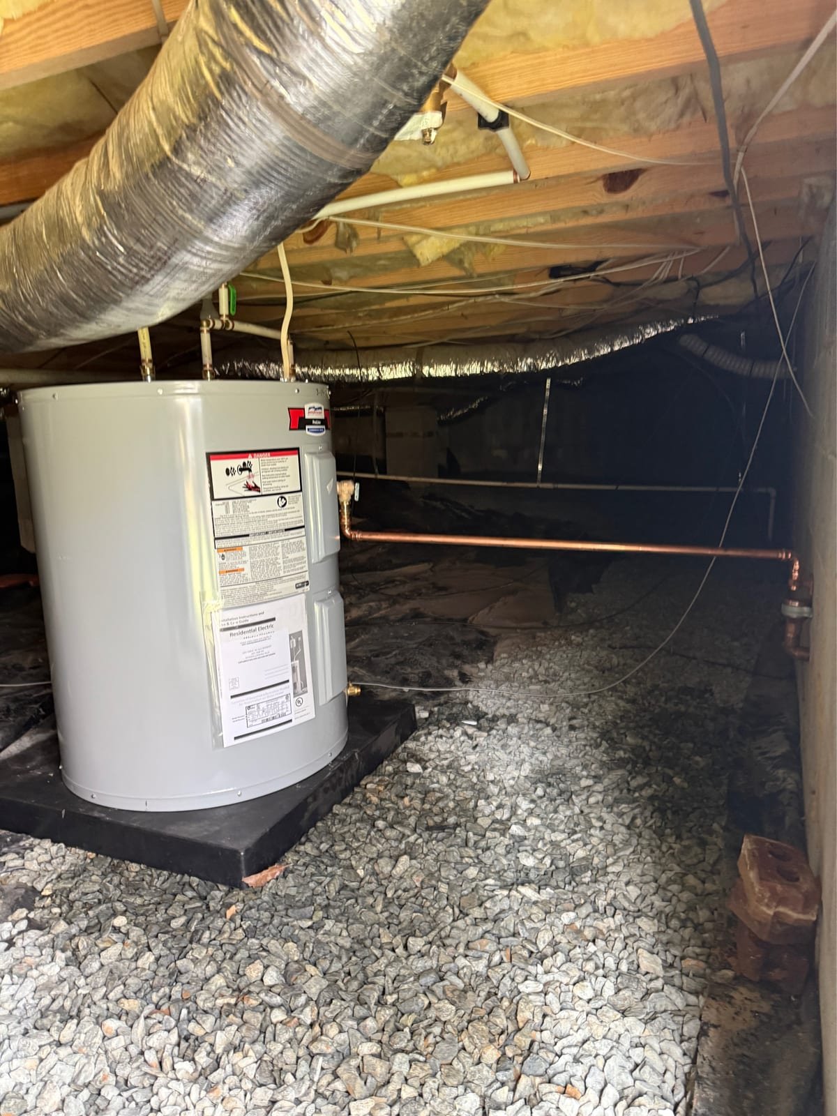 New electric water heater installed in place of a failed unit