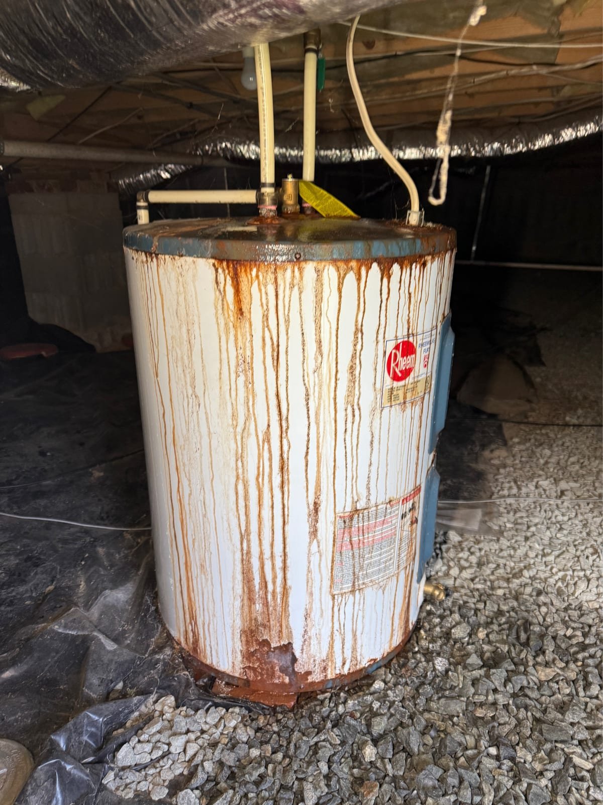 Old corroded electric water heater before replacement
