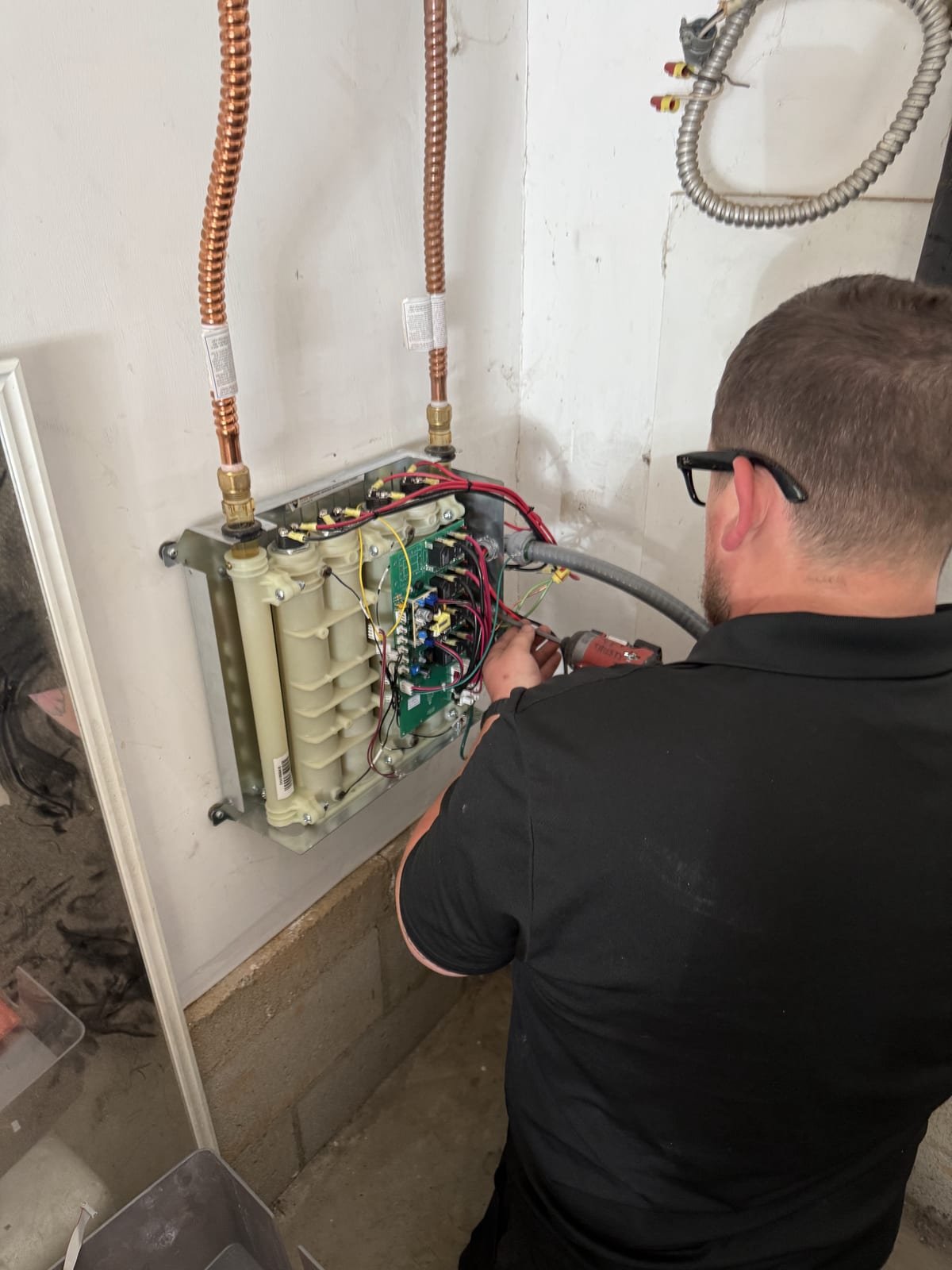 Electric tankless water heater opened for service and inspection