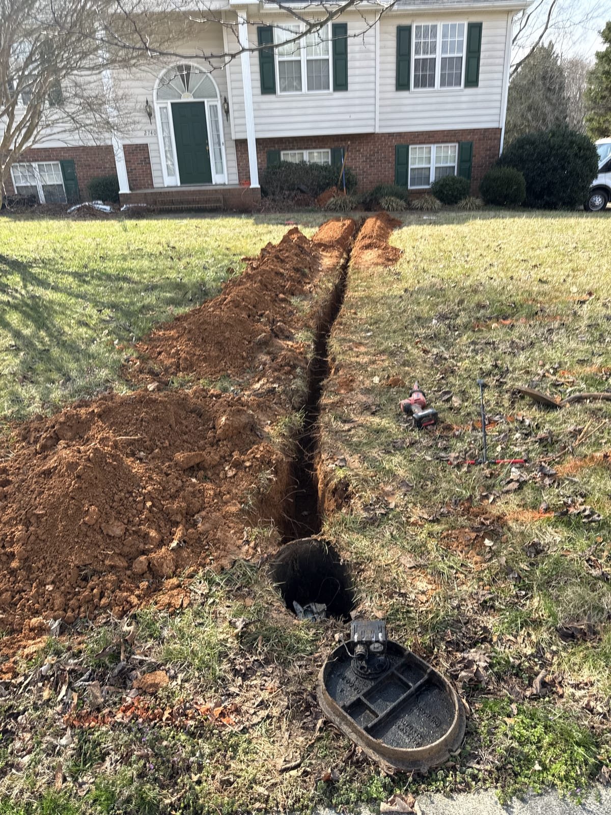 New water service line run in an open trench from the meter toward the house